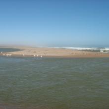 The Orange River Mouth from the Namibian side looking south.  Pelicans, cormorants and large flocks of terns are using the sandspit as a roost.