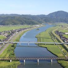 A landscape of Lower Maruyama River taken from Toyooka Bridge located in the site "Lower Maruyama River and the surrounding rice paddies"