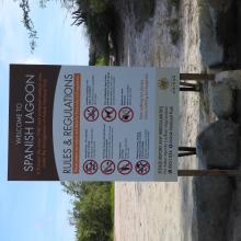 English language information panel informing tourists about the rules and regulations at Ramsar site Spaans Lagoen.